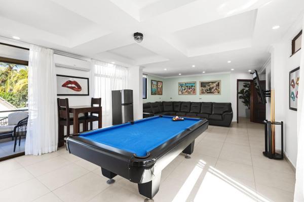 Pool table with bright windows in second floor living room