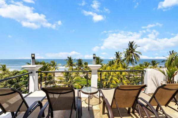 Rooftop lounge area with tropical view