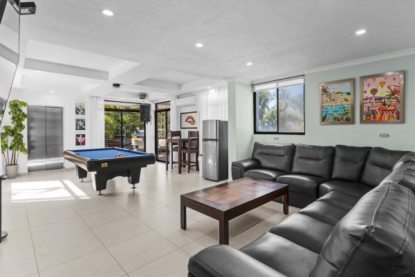 Second floor living room with pool table and sectional sofa