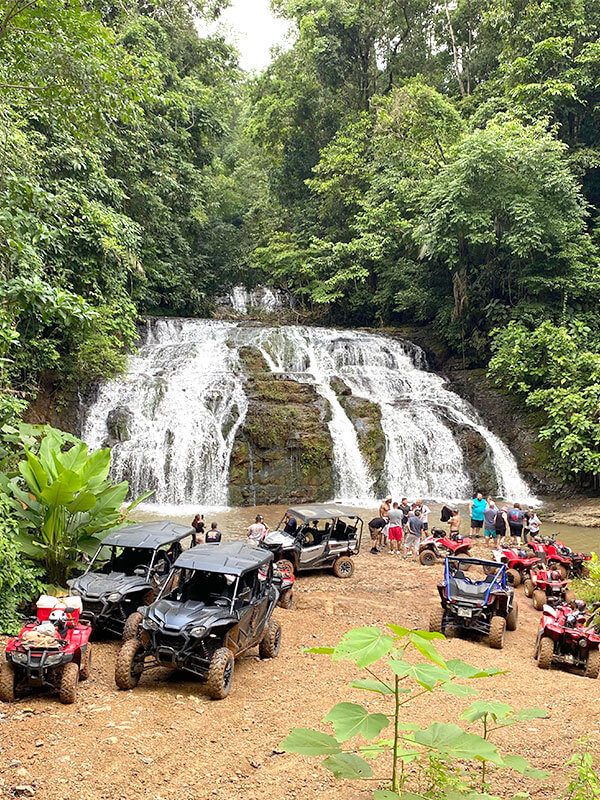 ATV and side by side vehicles parked at jungle waterfall on tour near Jaco Costa Rica