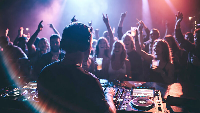 Vibrant Jaco Beach nightlife with bars and clubs lit up at night