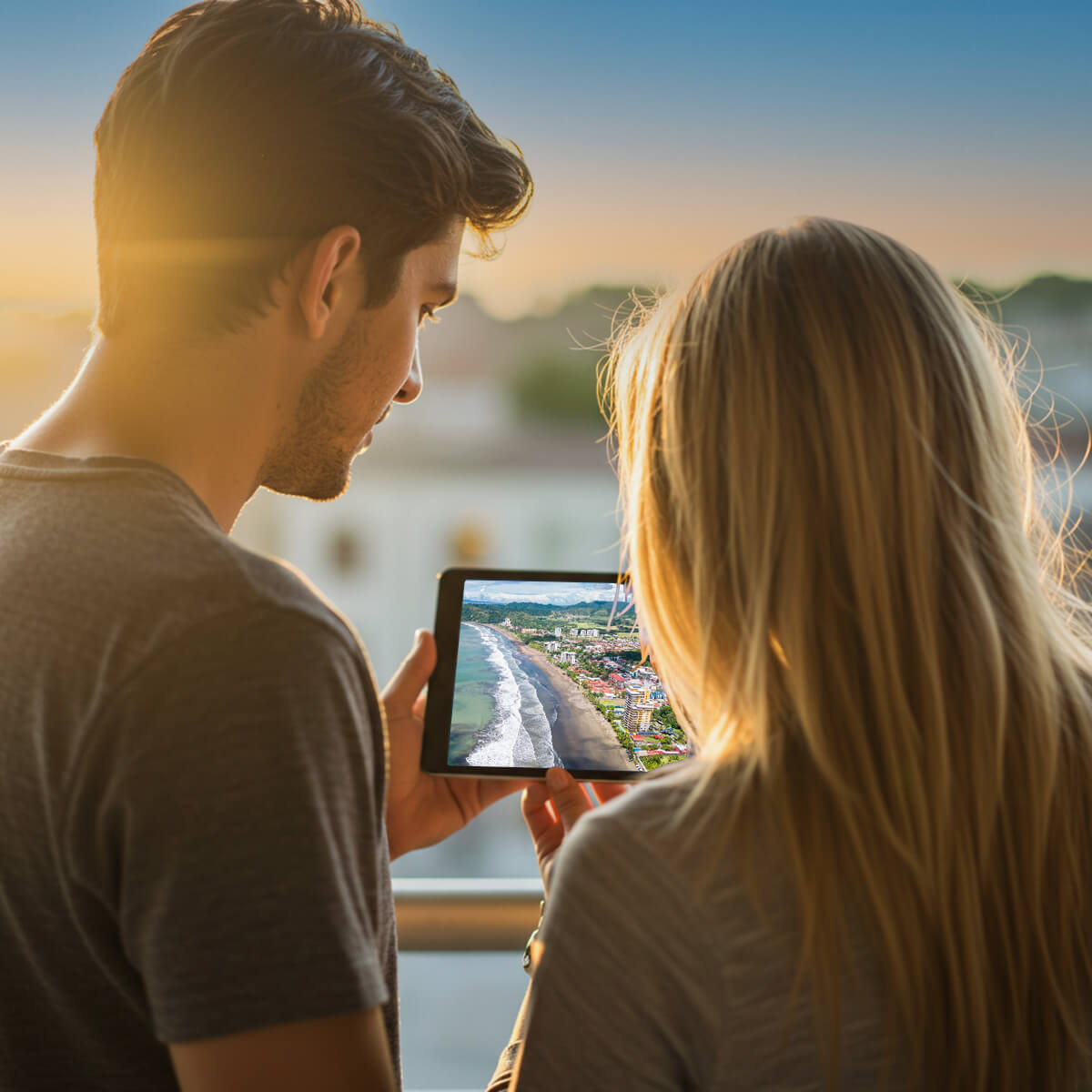 Couple reading JacoVIP travel guide page on a tablet