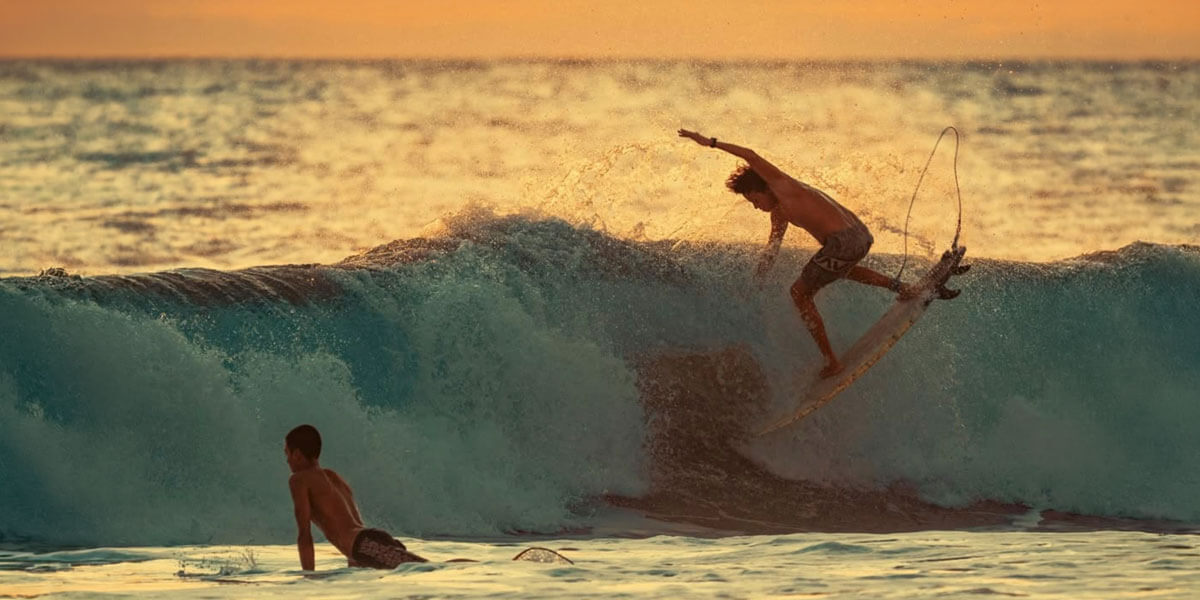 Advanced surfer on a large wave at Playa Hermosa Costa Rica at golden hour