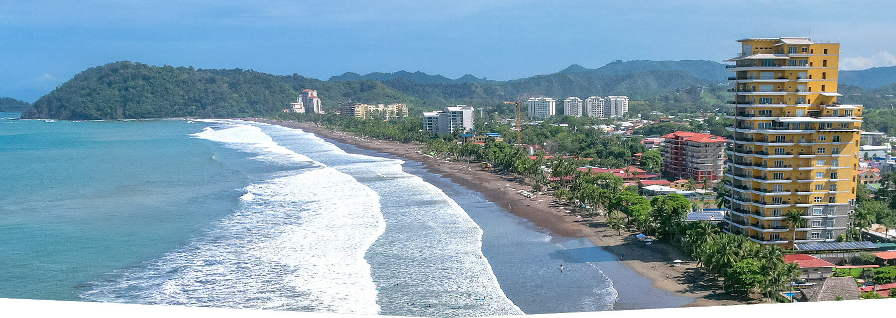 Aerial view of Jaco Beach, Costa Rica showing the coastline and surrounding rainforest