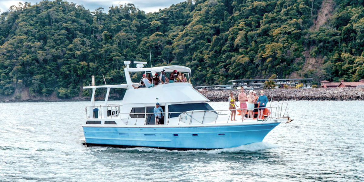Private charter boat cruising the Pacific coast near Jaco Costa Rica with group on deck
