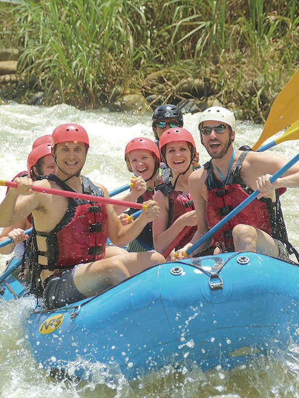 Group of friends white water rafting on the Savegre River near Jaco Costa Rica