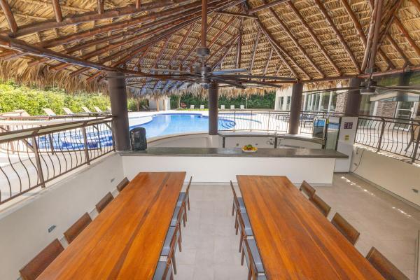 View of the big rancho and some dining tables in the back patio of Rancho de Suenos