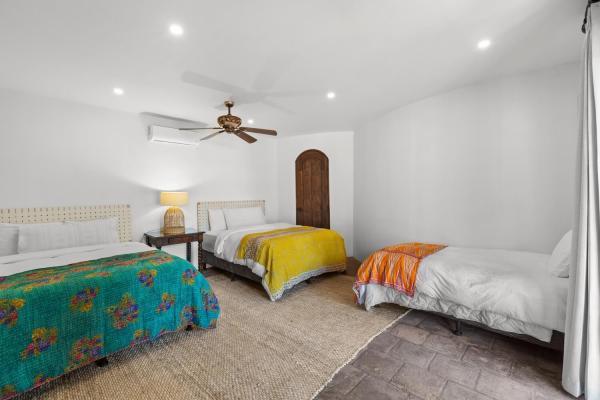 Bedroom 4 with two double beds and a single bed at Villa Antigua, a private pool villa Costa Rica second floor