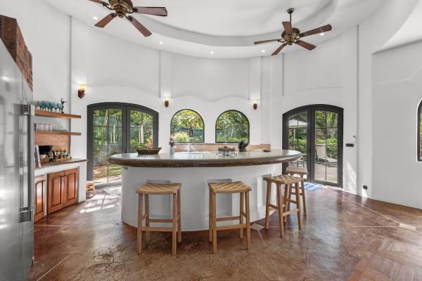 Modern fully equipped kitchen at Villa Antigua, a Costa Rica villa rental with stone counters and bar seating