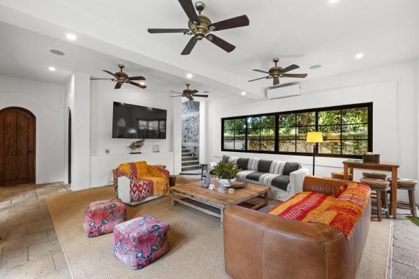 Open floor plan connecting kitchen, dining, and living rooms at South Beach Villa Antigua in Jaco Beach
