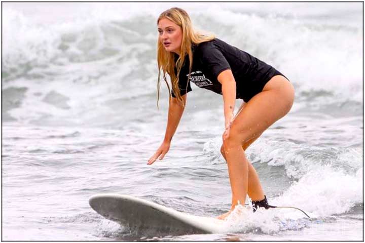 Girl learning to surf in Costa Rica