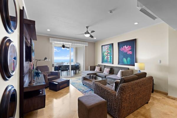Living room at The Palms 1002 looking out to the balcony and Jaco Beach ocean view