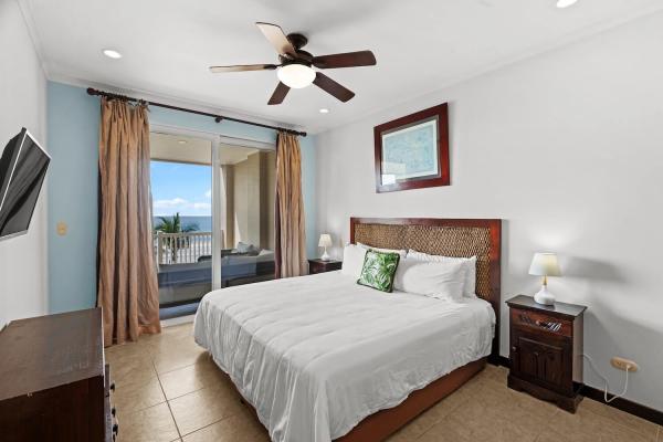 Primary bedroom with king bed at The Palms Condo 504