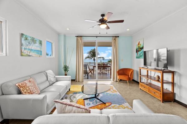 Comfortable living space in The Palms Condo 504 with balcony access