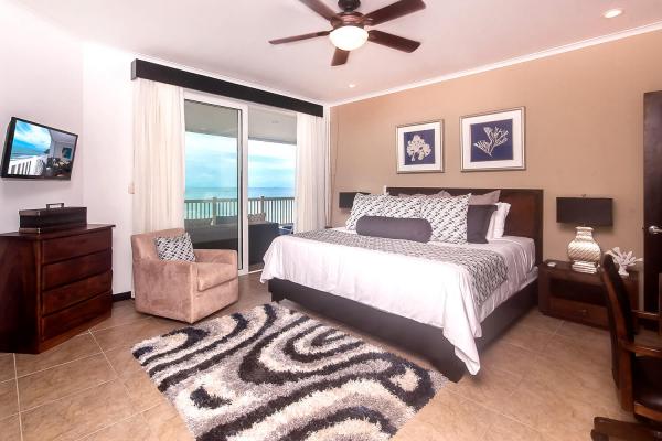 The Palms 902 master bedroom with king bed and ocean views