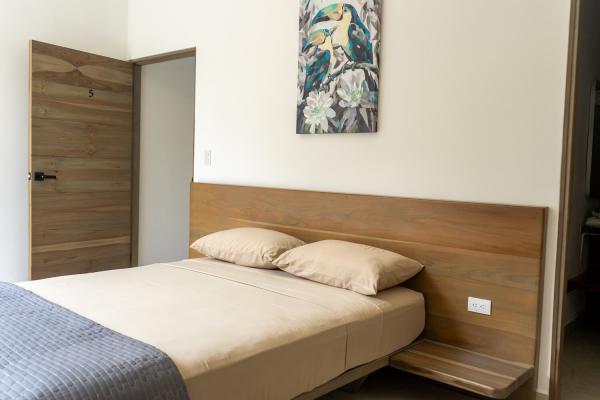 1 Queen Bed Second floor bedroom 5 with queen bed and tropical artwork