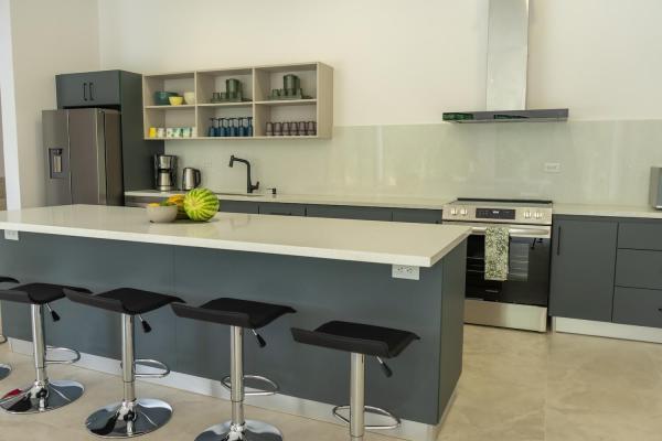 Kitchen island with four bar stools and stainless appliances