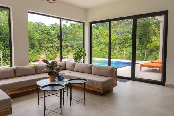 Living room sectional sofa beside sliding glass doors to the pool