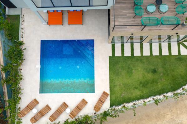 Overhead aerial view of the pool, sun loungers and garden lawn