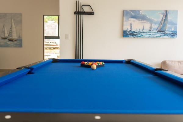Upstairs lounge pool table with wall mounted cue rack