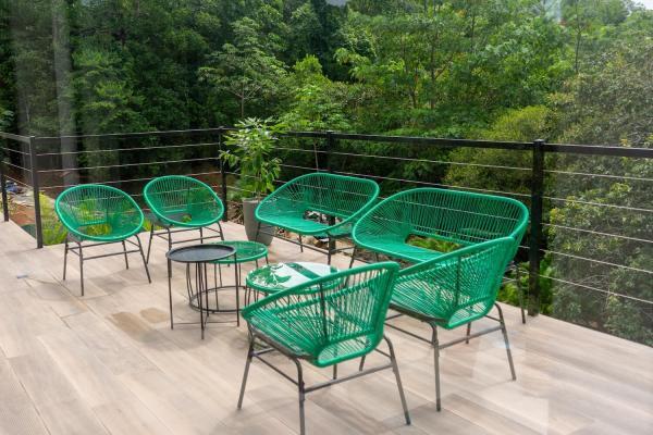 Second floor deck seating surrounded by jungle trees