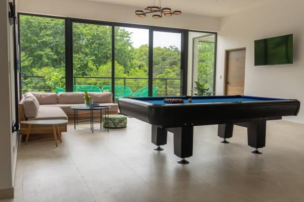 Upstairs lounge with pool table, sectional sofa and TV
