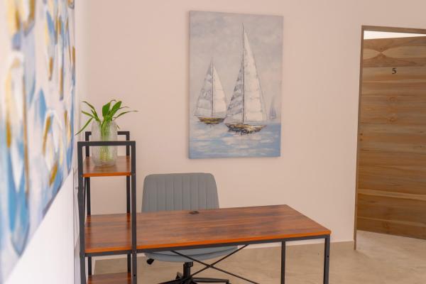 Upstairs work desk with office chair and sailboat painting