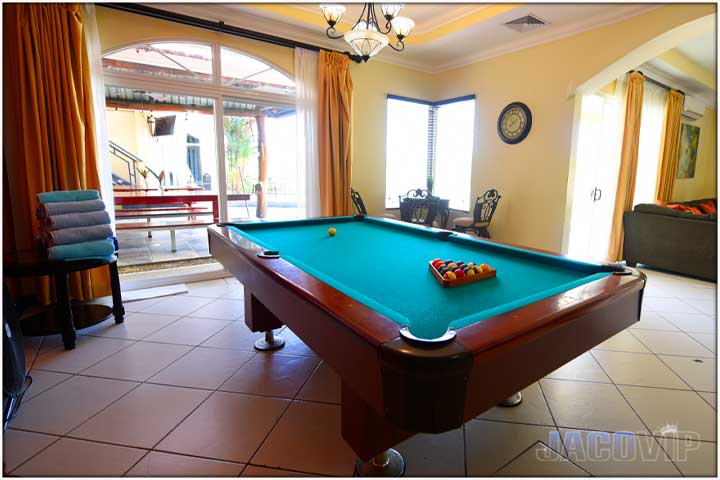 Pool table with orange wall