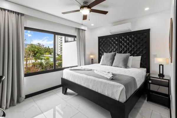 1 King Bed Stunning king bedroom with tufted headboard, bright tropical views, and a private ensuite at this Costa Rica villa