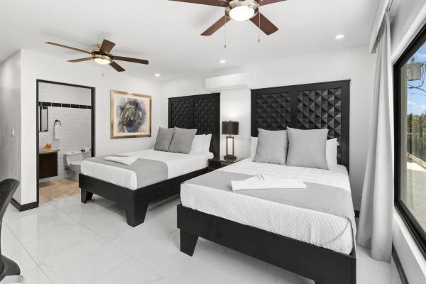 2 Queen Beds Airy king bedroom with panoramic window and tufted headboard overlooking tropical garden views, Jaco Beach villa
