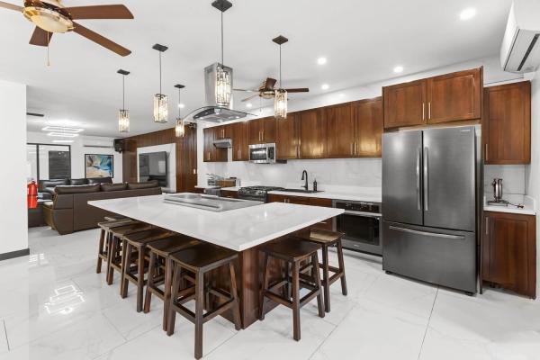 Gourmet kitchen with Teppanyaki grill, large central island, and stainless steel appliances, Costa Rica vacation villa