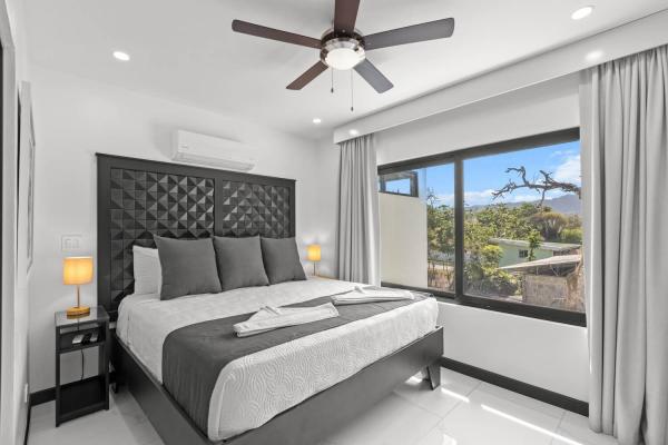 Bright king bedroom with large windows flooding the room with natural light and ensuite bathroom, Costa Rica