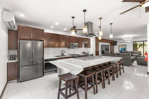 Fully equipped gourmet kitchen with stainless steel appliances, marble island and barstool seating, Costa Rica