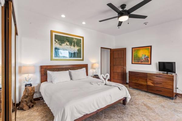 1 King Bed Bedroom 2 with king bed, white duvet, and elegant décor