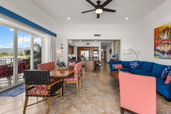 Living area with north-facing sliders showing ocean and mountain views
