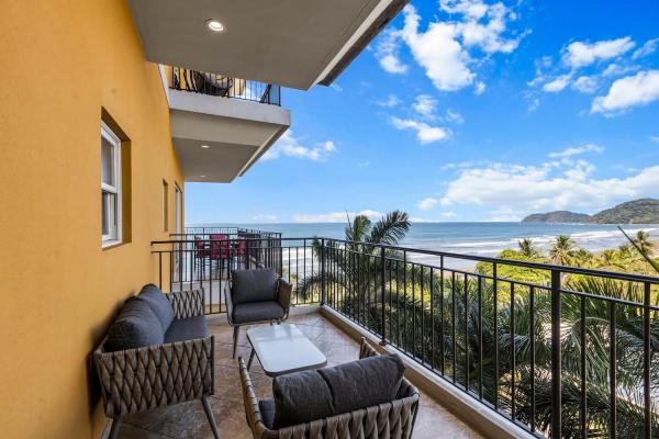Private master balcony with outdoor seating and sweeping ocean views