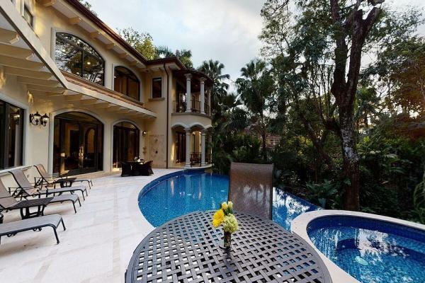 Poolside sunbathing terrace at Casa Vista Paraiso with comfortable loungers