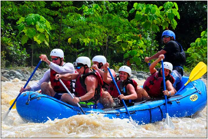 White water rafting with lush green tropical scenery