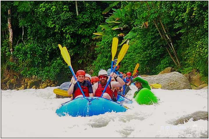 Paddles p in the air during rafting tour