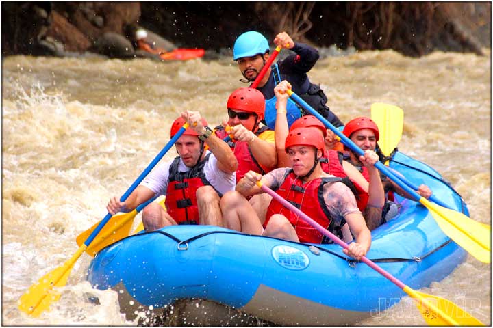 Rafting guide with group on the river