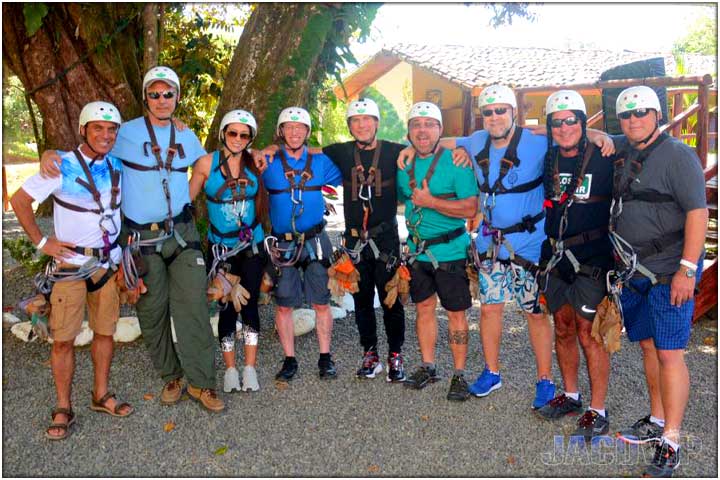 Large group of guys posing after zipline canopy tour in costa rica